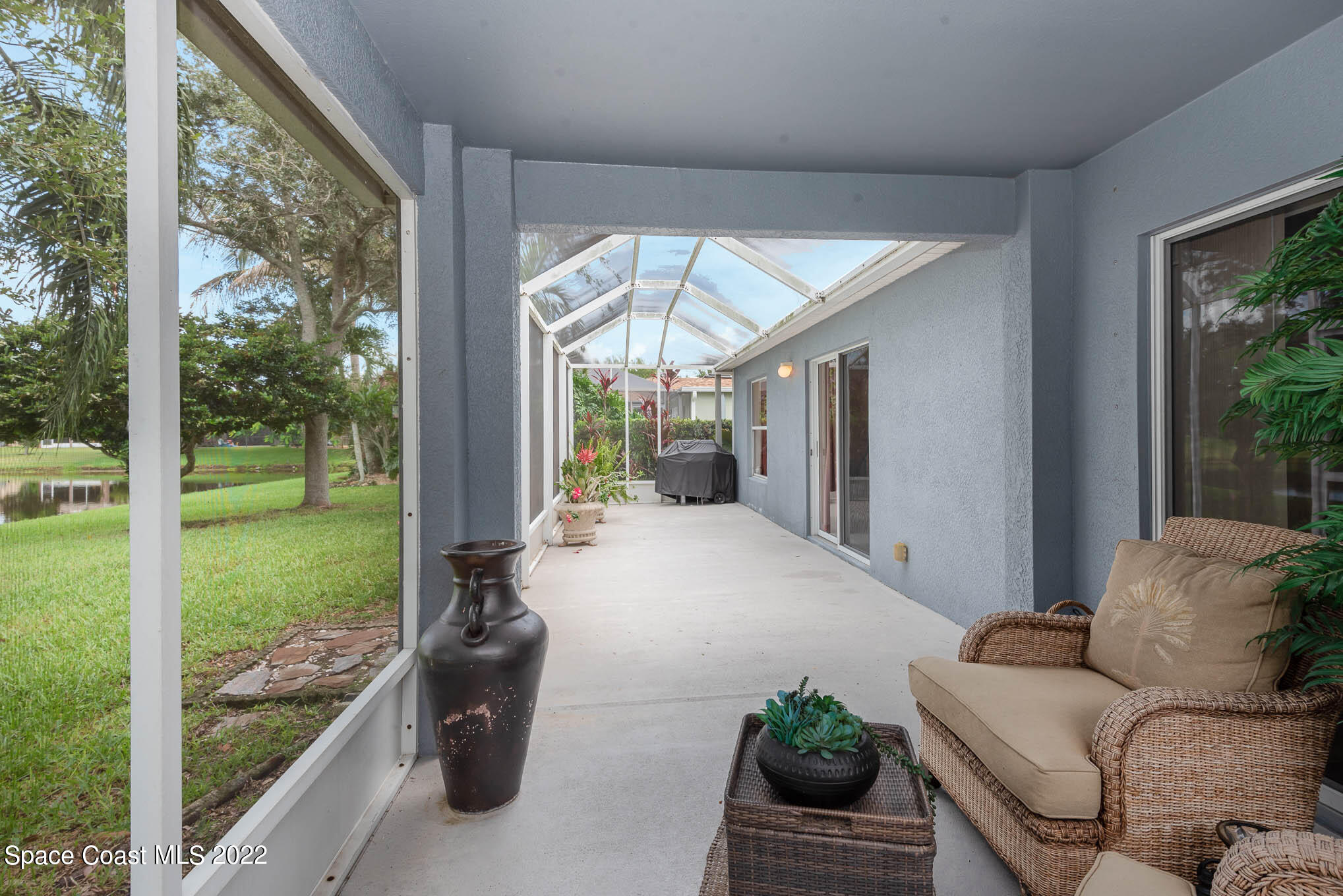 1063 Brumpton Place Rockledge, FL 32955 - Photo 21 of 33 a living room with furniture and a floor to ceiling window