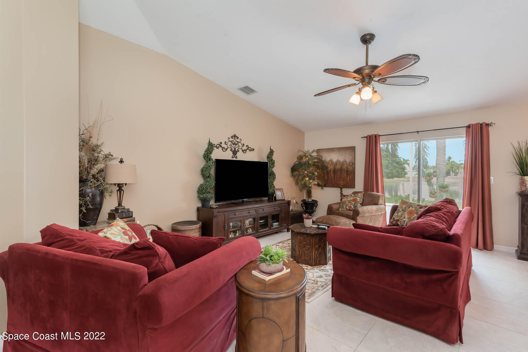 1063 Brumpton Place Rockledge, FL 32955 - Photo 3 of 33 a living room with furniture a flat screen tv and a large window