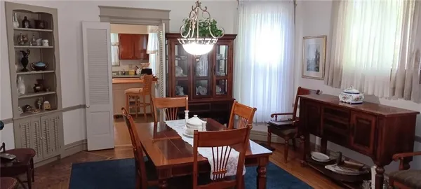 a view of a dining room with furniture and a window