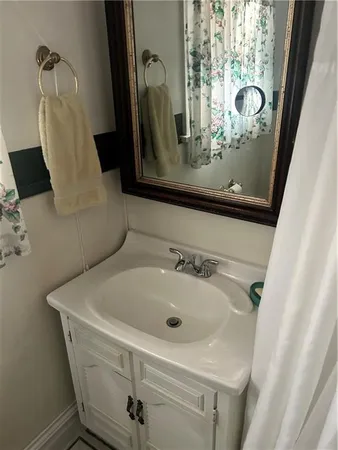 a bathroom with a sink and mirror