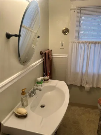 a bathroom with a sink and a mirror
