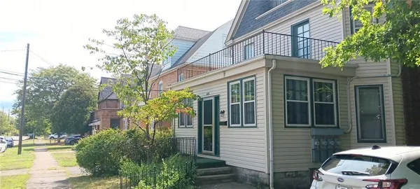 a front view of a house with trees