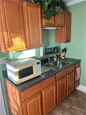 a kitchen with granite countertop cabinets stainless steel appliances a sink and a counter space