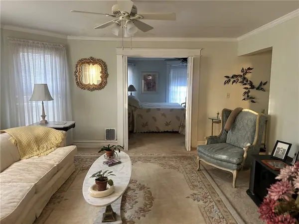 a living room with furniture and a mirror