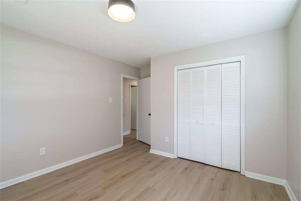 511 Lee Byrd Road Loganville, GA 30052 - Photo 16 of 32 a view of an empty room with wooden floor
