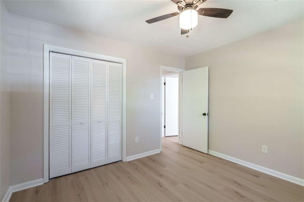 511 Lee Byrd Road Loganville, GA 30052 - Photo 18 of 32 wooden floor in an empty room with a window