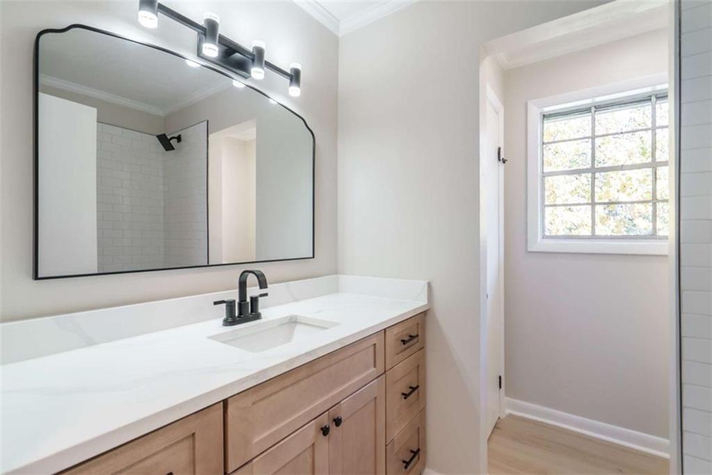 511 Lee Byrd Road Loganville, GA 30052 - Photo 21 of 32 a bathroom with a sink and a mirror