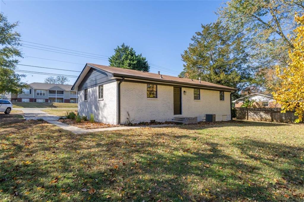 511 Lee Byrd Road Loganville, GA 30052 - Photo 25 of 32 a view of a house with backyard and tree