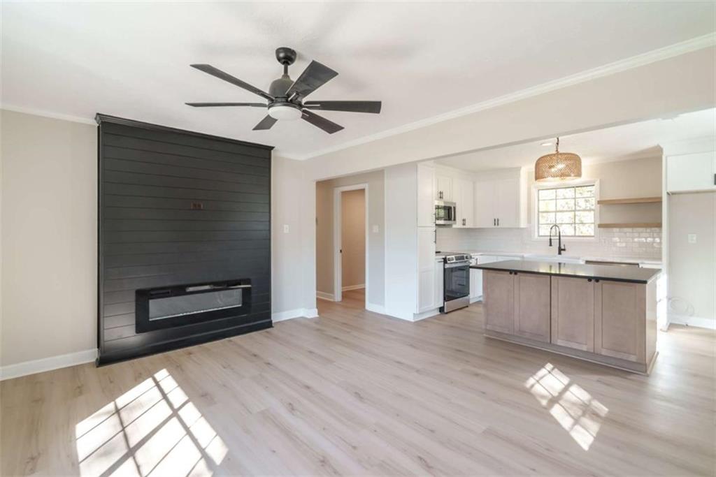 511 Lee Byrd Road Loganville, GA 30052 - Photo 7 of 32 a view of kitchen with granite countertop cabinets and wooden floor