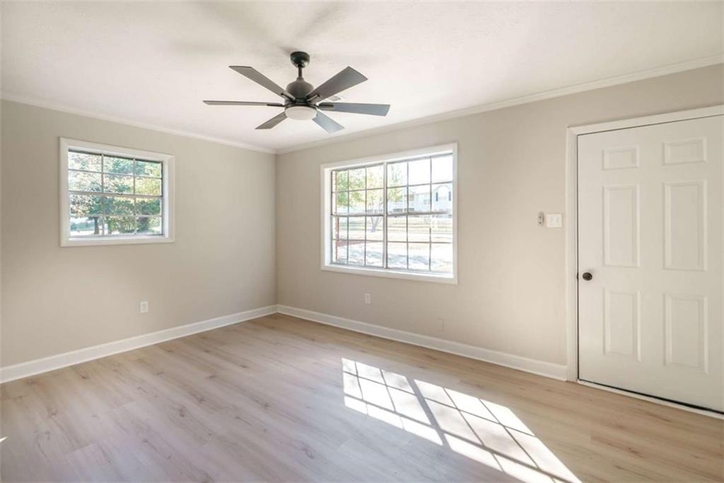 511 Lee Byrd Road Loganville, GA 30052 - Photo 9 of 32 a view of an empty room with wooden floor and a window