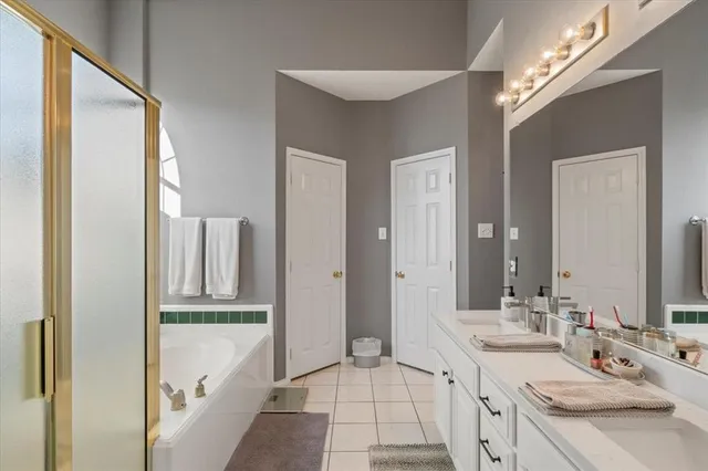a spacious bathroom with a double vanity sink and a mirror