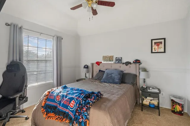 a bedroom with a bed and a chair