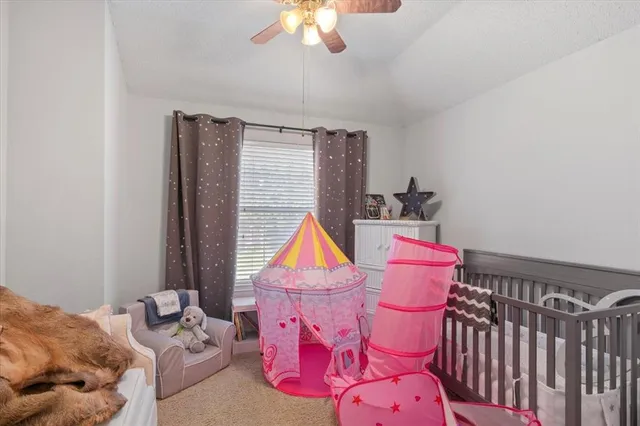 a bedroom with furniture and a window