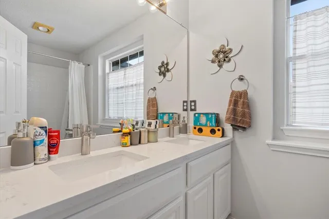 a bathroom view with a sink and a window