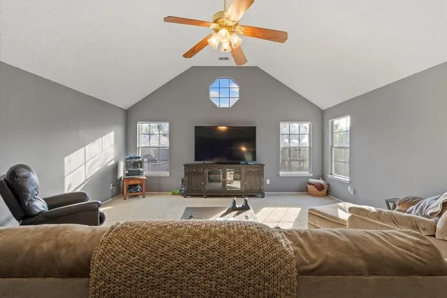 a living room with furniture a couch and a flat screen tv