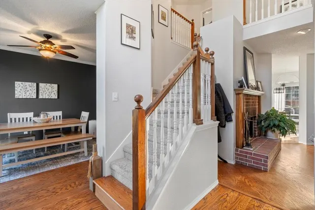 a view of entryway and hall with wooden floor