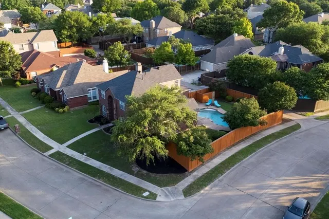 an aerial view of a house with a yard and outdoor seating