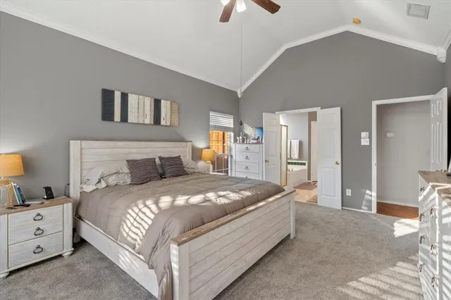 a spacious bedroom with a bed and a chandelier