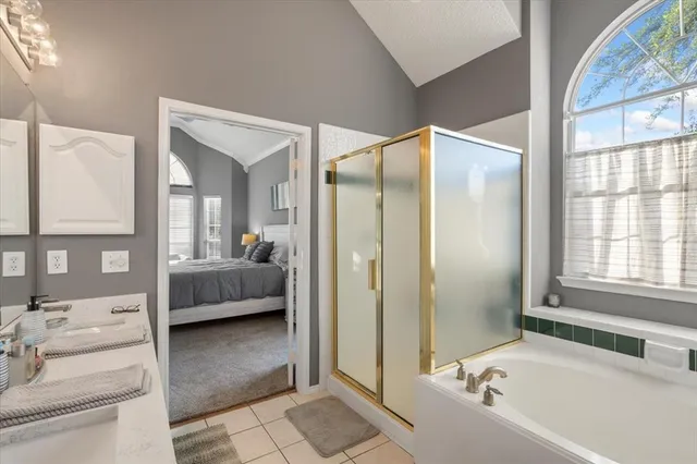 a bathroom with a tub shower and a sink