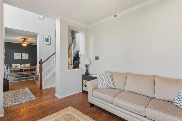 a living room with furniture and wooden floor