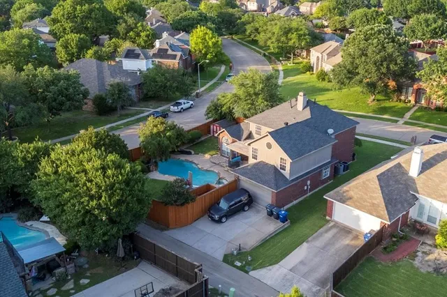 an aerial view of a house with garden space and street view