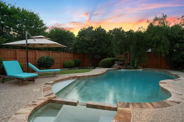 a view of a backyard with swimming pool