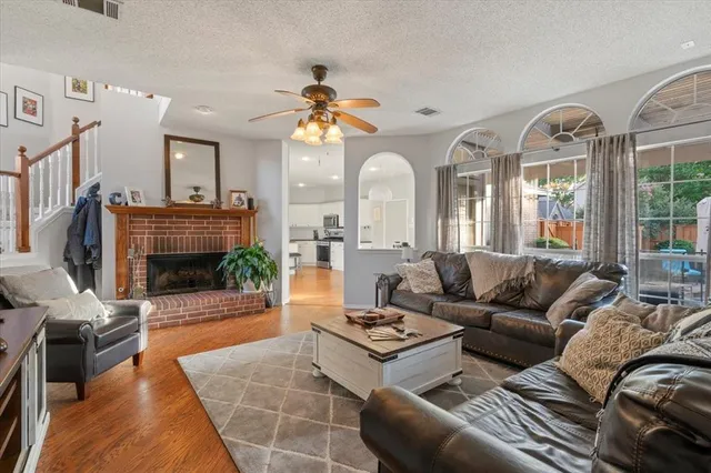 a living room with furniture a fireplace and a flat screen tv