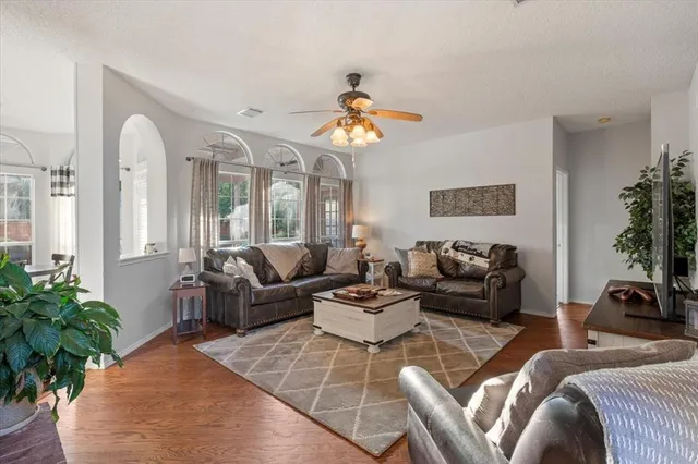 a living room with furniture flowers and a chandelier