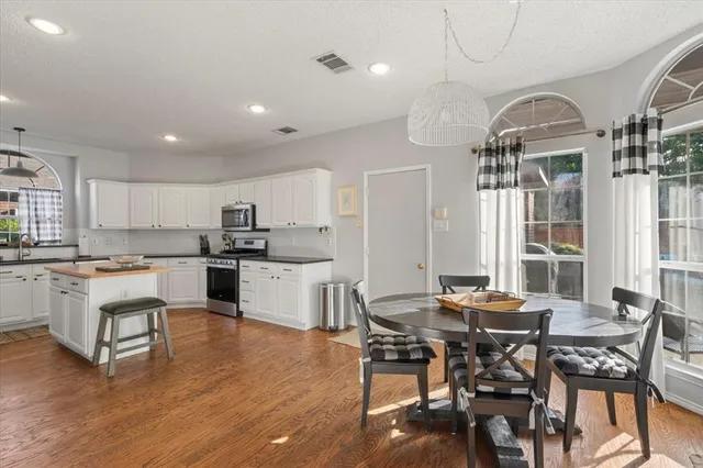 a living room with stainless steel appliances kitchen island granite countertop furniture and a kitchen view