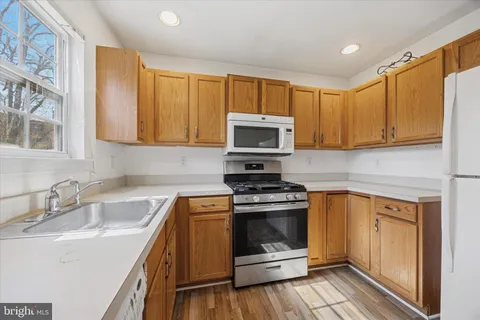a kitchen with a sink stove and microwave