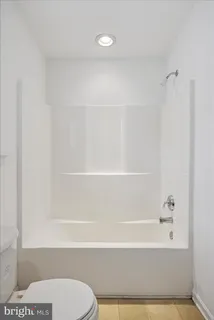 a bathroom with a bathtub and a toilet
