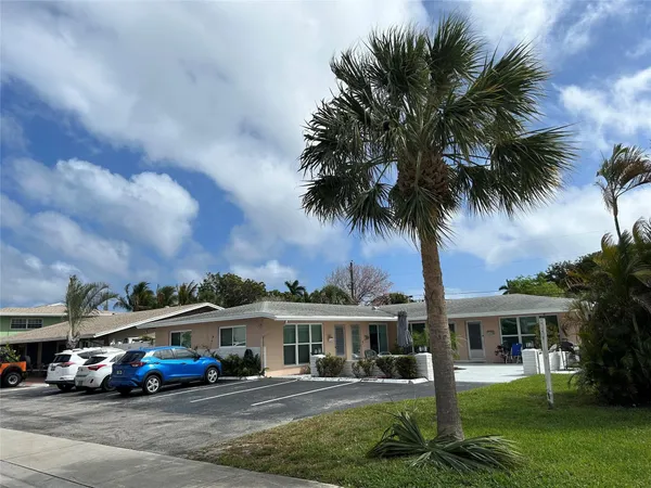 a front view of residential houses and yard with green space