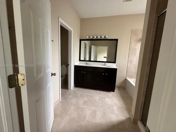 a spacious bathroom with a mirror sink and vanity