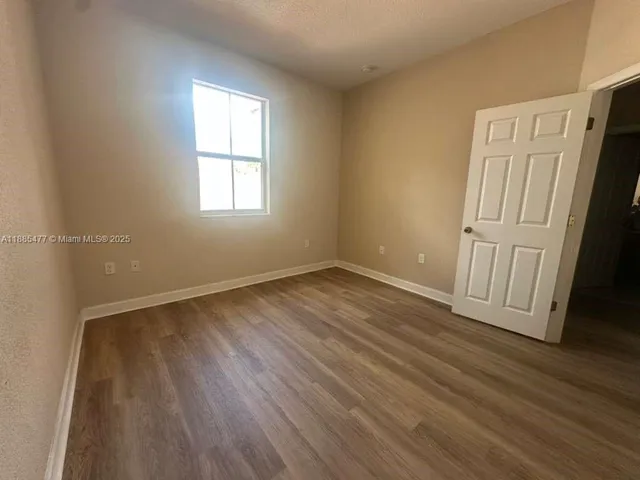 a view of a hallway and wooden floor