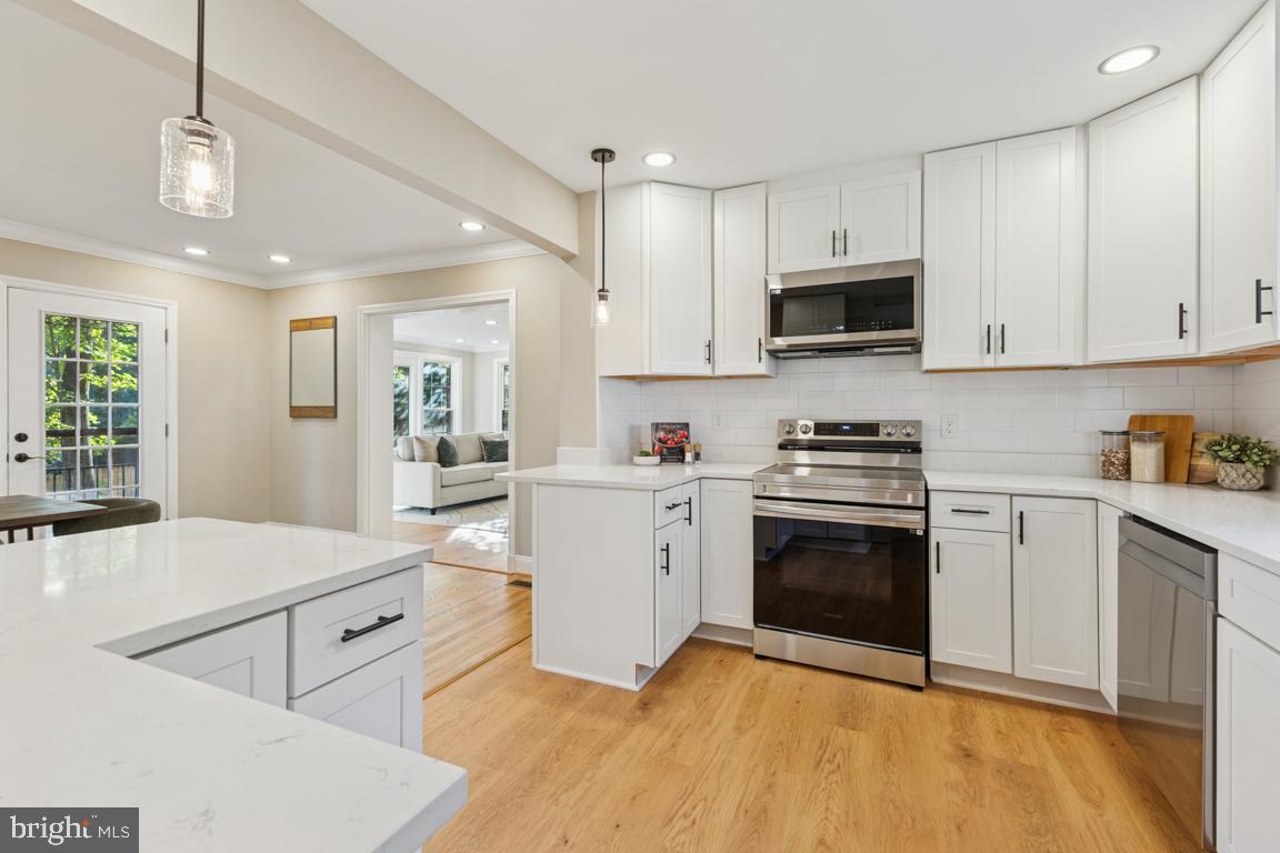 1901 Belle Haven Road Alexandria, VA 22307 - Photo 11 of 52 a kitchen with white cabinets stainless steel appliances and sink