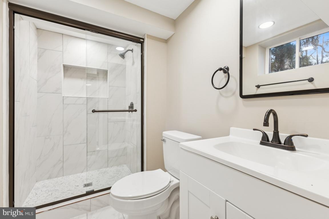 1901 Belle Haven Road Alexandria, VA 22307 - Photo 32 of 52 a bathroom with a sink a toilet and shower