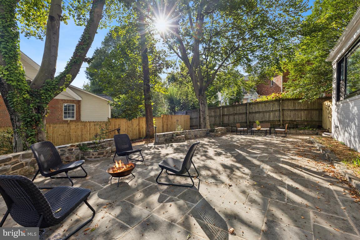 1901 Belle Haven Road Alexandria, VA 22307 - Photo 43 of 52 a backyard of a house with table and chairs and wooden fence