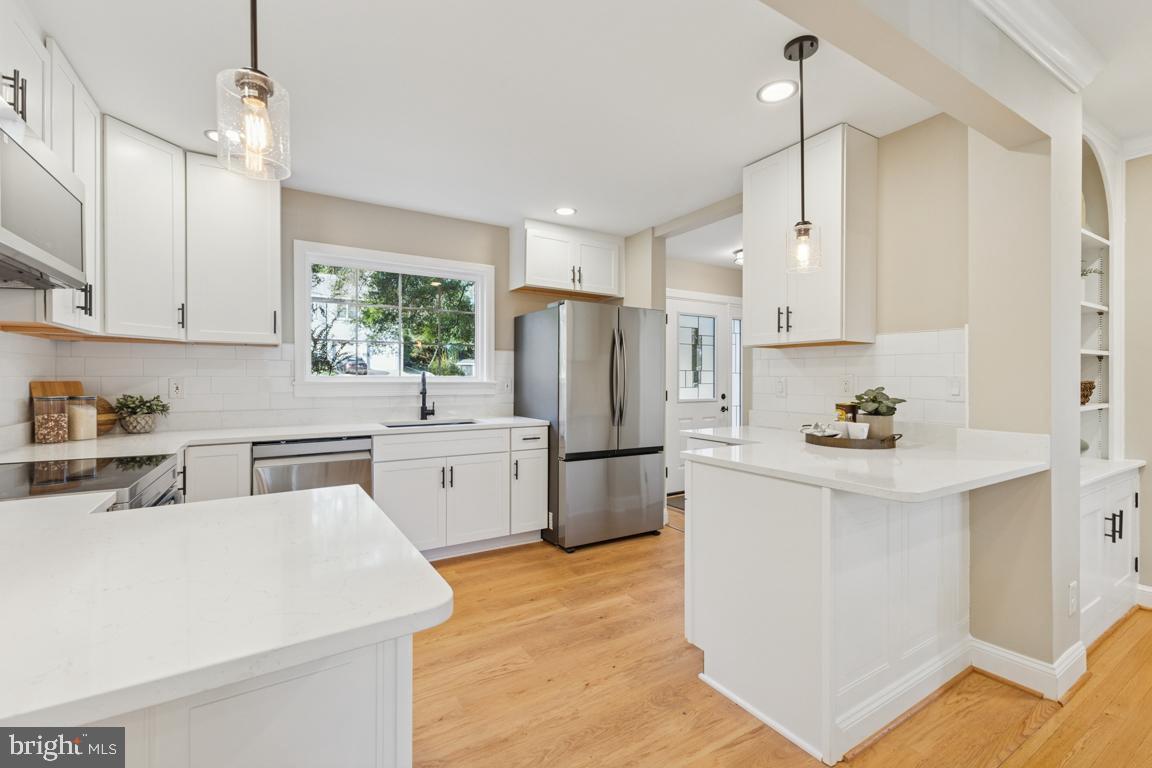 1901 Belle Haven Road Alexandria, VA 22307 - Photo 9 of 52 a kitchen with a sink a refrigerator and white cabinets