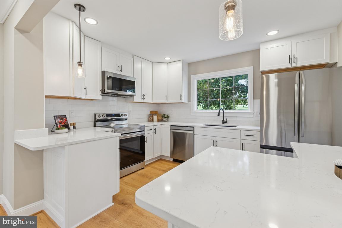 1901 Belle Haven Road Alexandria, VA 22307 - Photo 10 of 52 a kitchen with white cabinets and stainless steel appliances