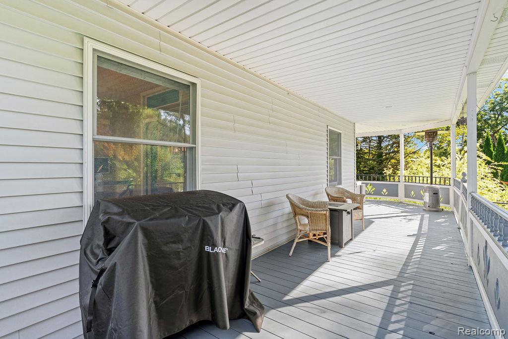1476 County Farm Road Howell, MI 48843 - Photo 37 of 53 Wooden porch featuring a grill