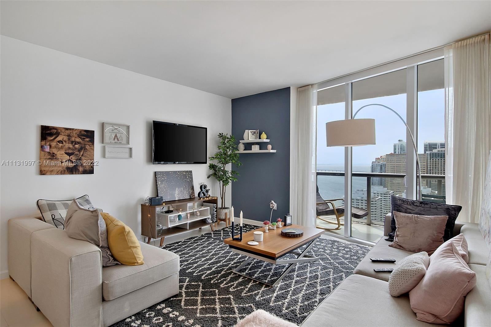 495 Brickell Avenue, Unit 3107 Miami, FL 33131 - Photo 11 of 41 a living room with furniture and a flat screen tv