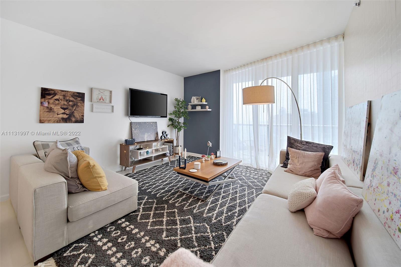 495 Brickell Avenue, Unit 3107 Miami, FL 33131 - Photo 12 of 41 a living room with furniture and a flat screen tv