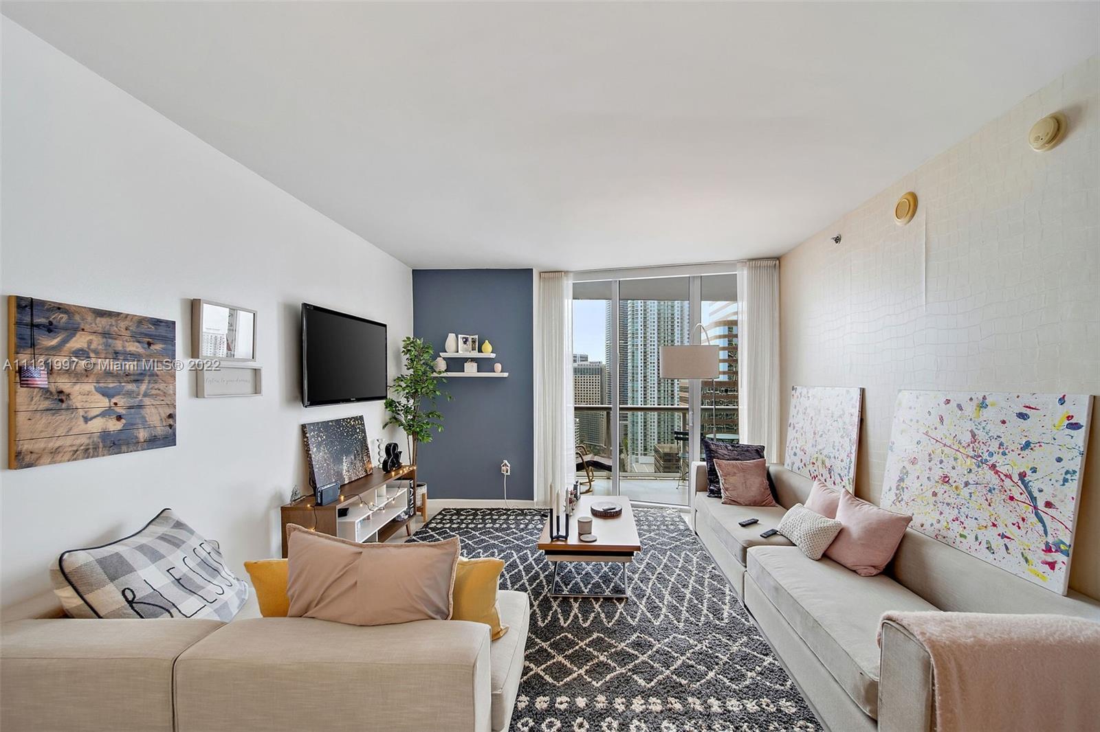 495 Brickell Avenue, Unit 3107 Miami, FL 33131 - Photo 13 of 41 a living room with furniture and a flat screen tv