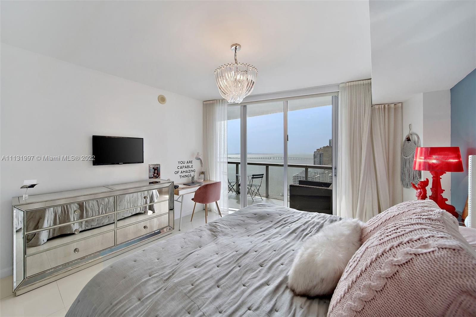 495 Brickell Avenue, Unit 3107 Miami, FL 33131 - Photo 19 of 41 a bedroom with a bed and a flat screen tv