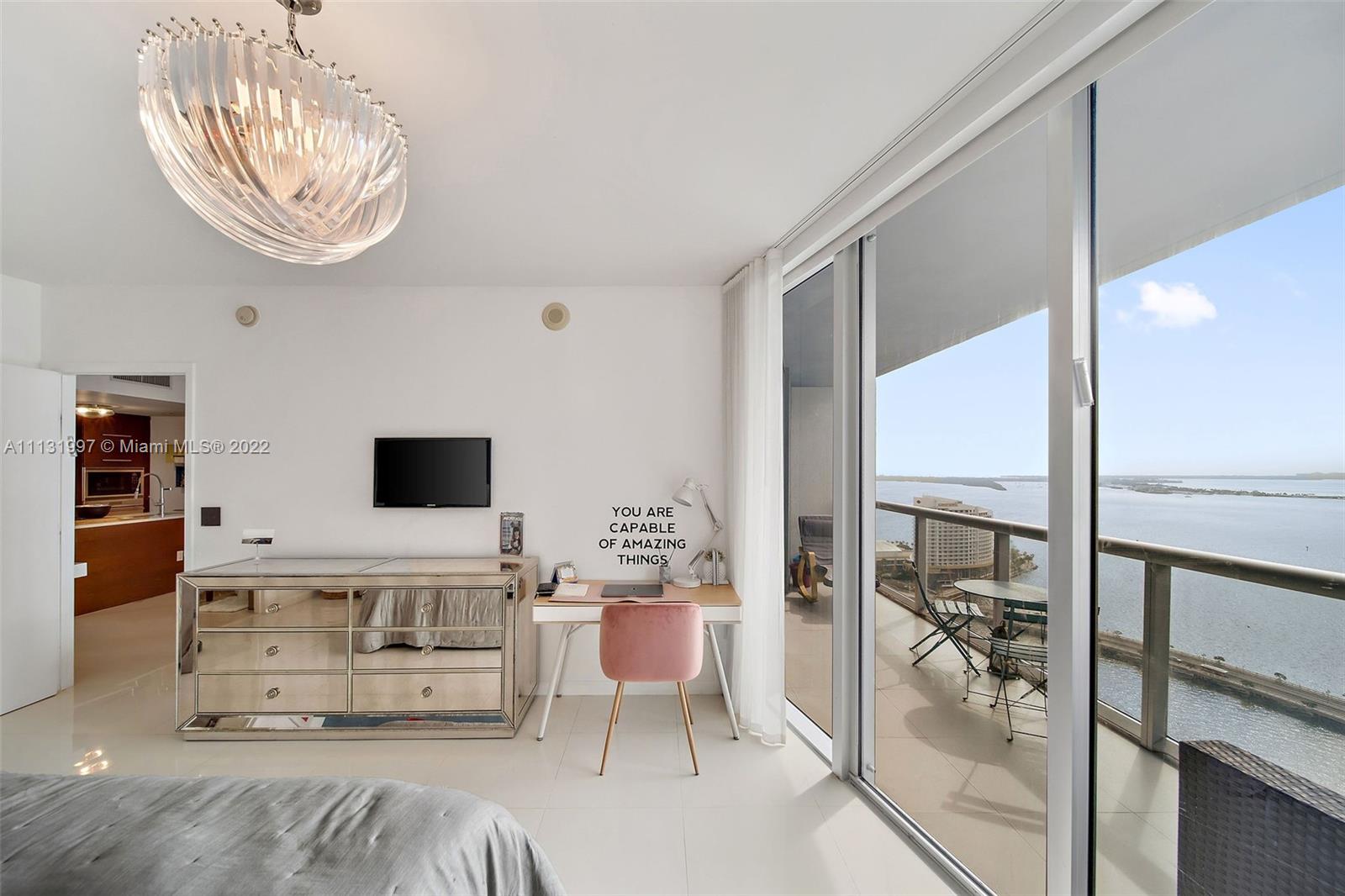 495 Brickell Avenue, Unit 3107 Miami, FL 33131 - Photo 20 of 41 a living room with furniture a rug potted plant and a large window