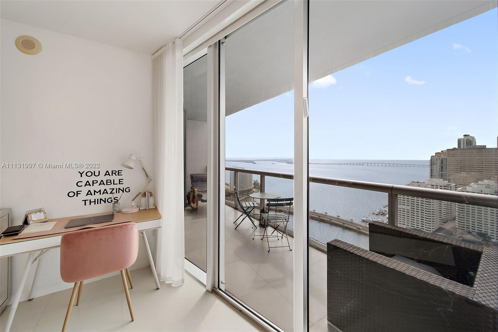 495 Brickell Avenue, Unit 3107 Miami, FL 33131 - Photo 22 of 41 a kitchen with a table chairs stove and sink