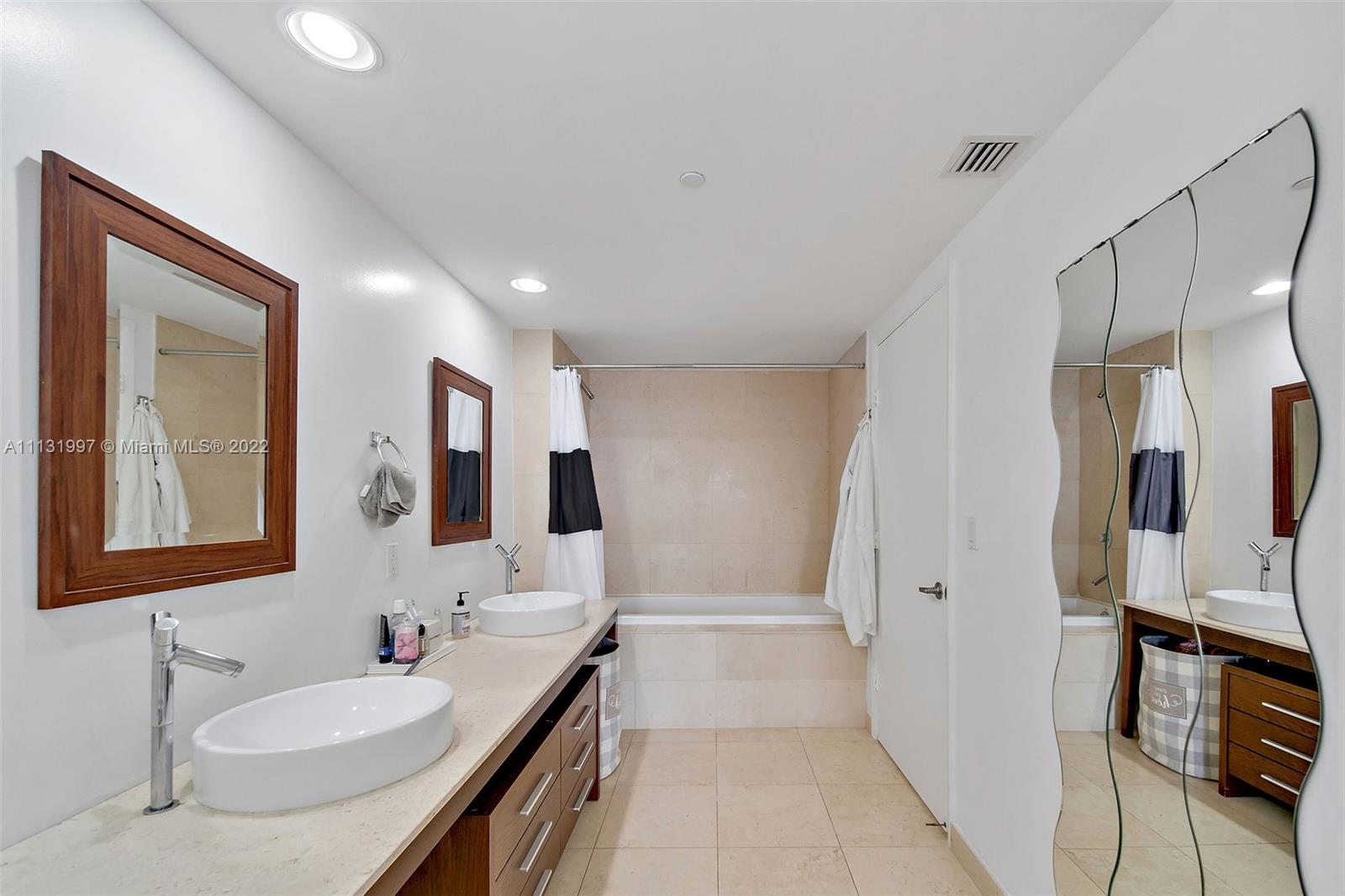 495 Brickell Avenue, Unit 3107 Miami, FL 33131 - Photo 24 of 41 a bathroom with double vanity sink and mirror