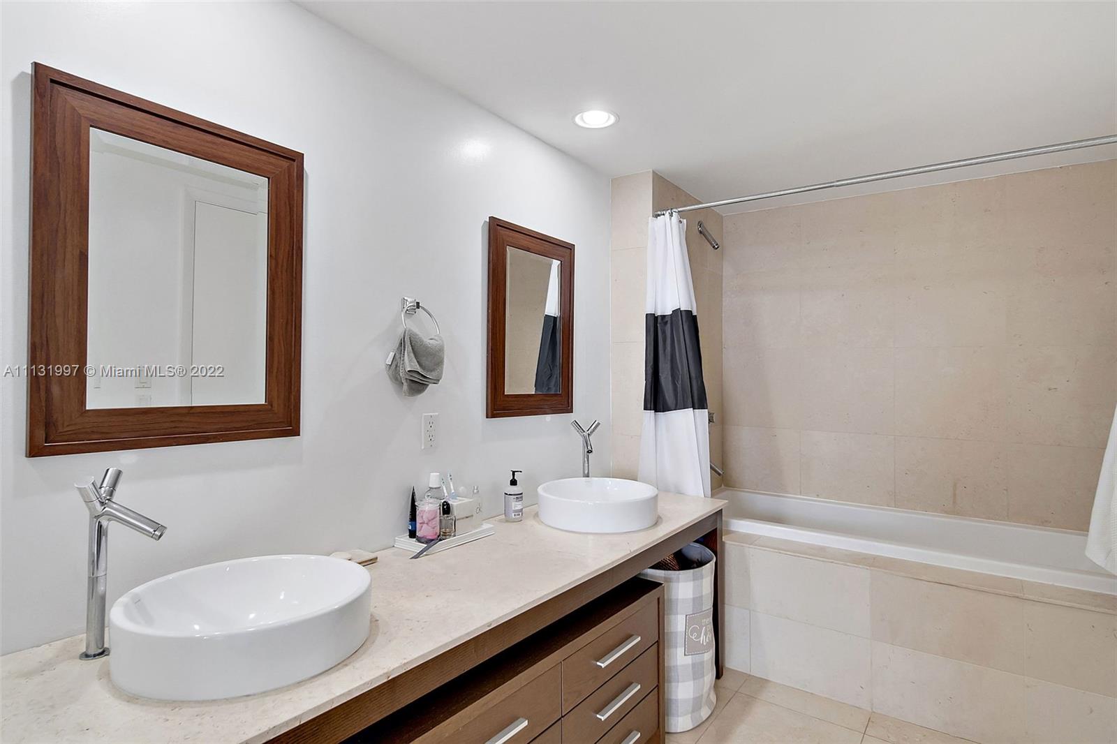 495 Brickell Avenue, Unit 3107 Miami, FL 33131 - Photo 25 of 41 a bathroom with a sink and a mirror