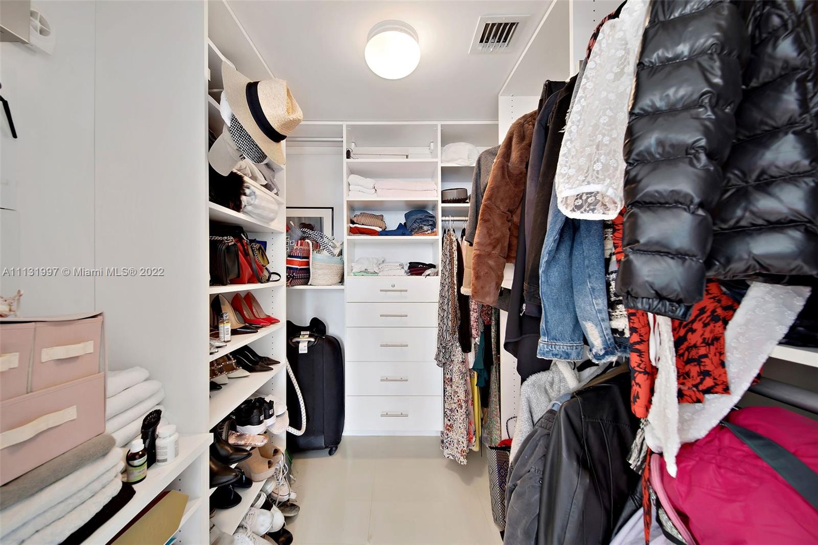 495 Brickell Avenue, Unit 3107 Miami, FL 33131 - Photo 27 of 41 a view of walk in closet with clothes and shoes