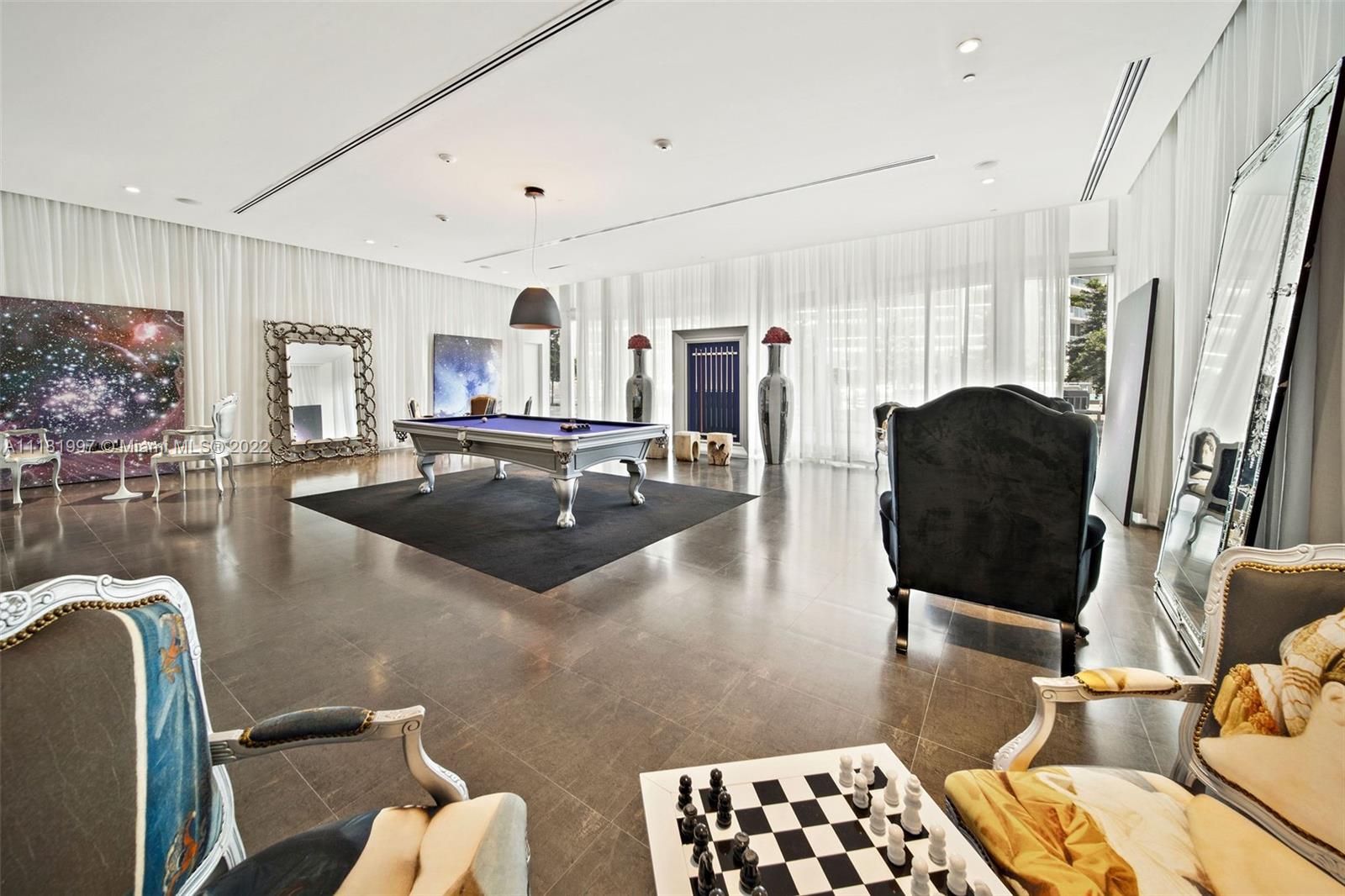 495 Brickell Avenue, Unit 3107 Miami, FL 33131 - Photo 30 of 41 a living room with furniture and a flat screen tv